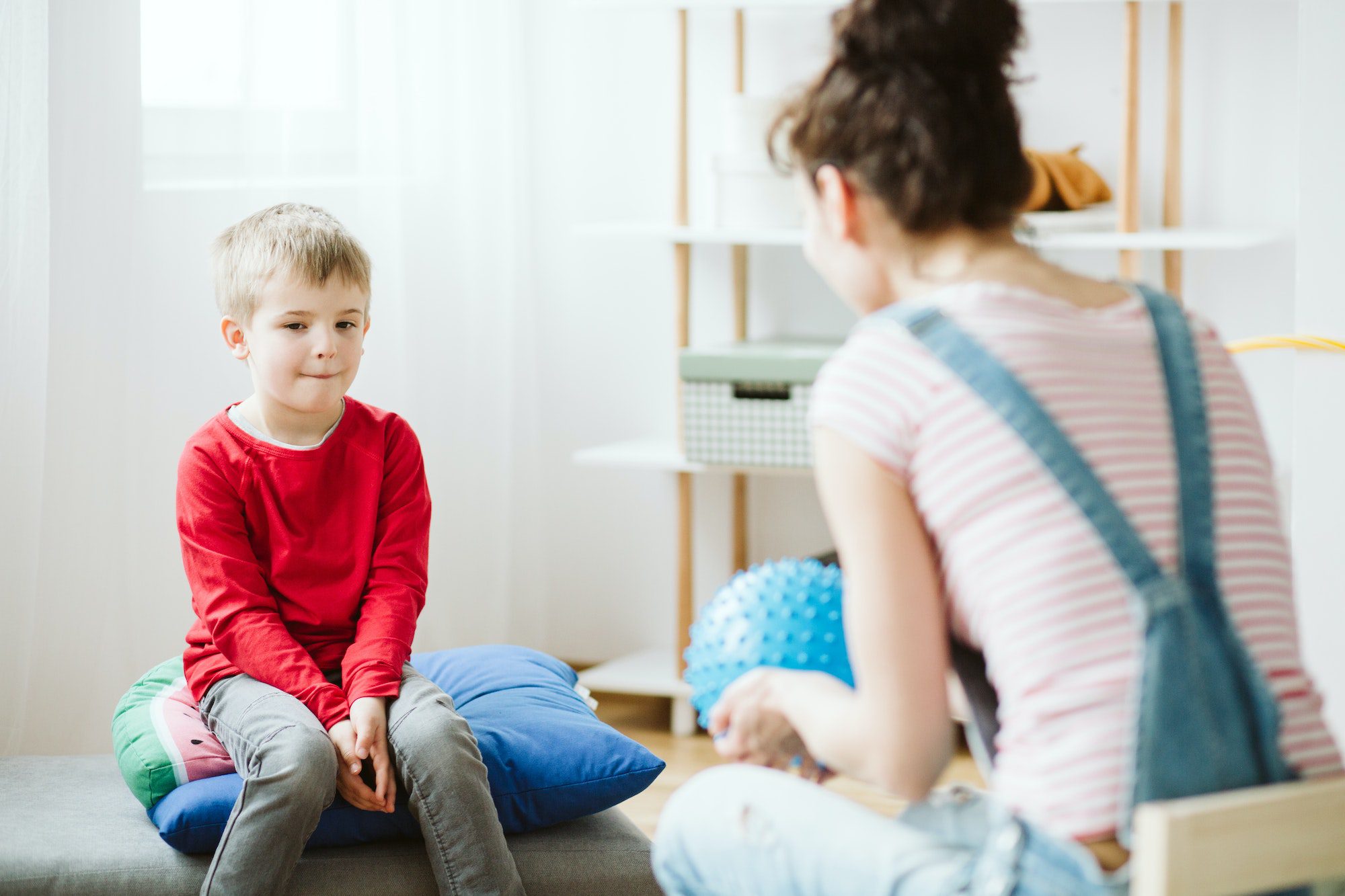 Playing with boy in therapy.